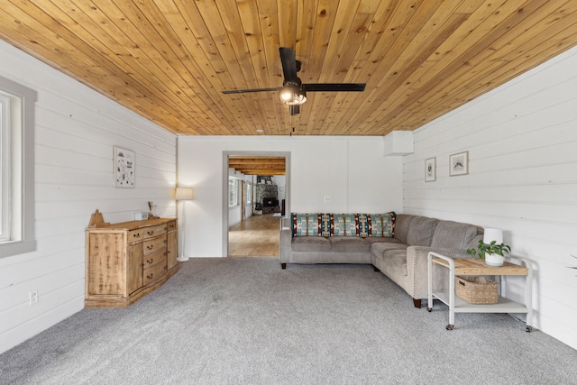 carpeted living room featuring wood ceiling and a ceiling fan