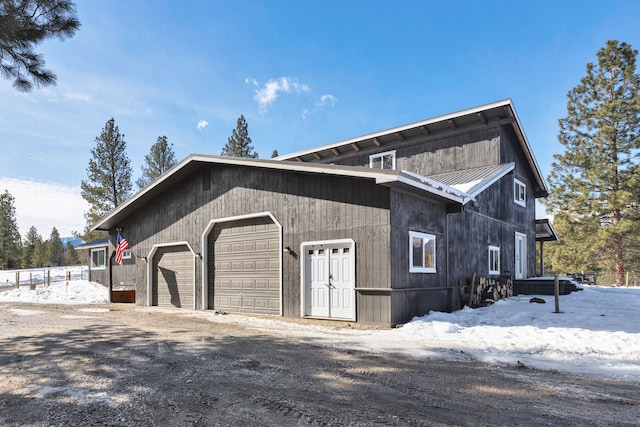 exterior space featuring metal roof and driveway