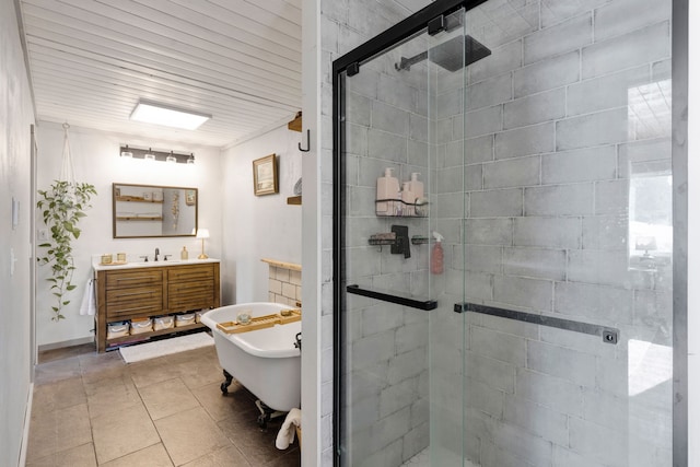 bathroom with a soaking tub, a shower stall, vanity, and tile patterned floors