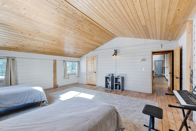 bedroom with wooden walls, light wood-type flooring, wood ceiling, and lofted ceiling