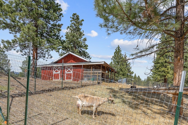 exterior space with fence and an outbuilding