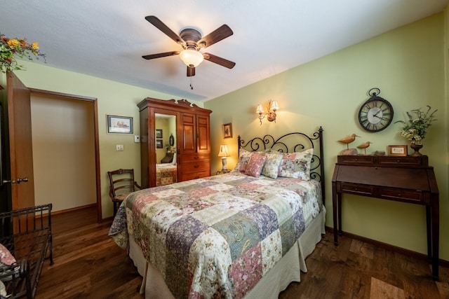 bedroom featuring ceiling fan, dark wood-style flooring, and baseboards