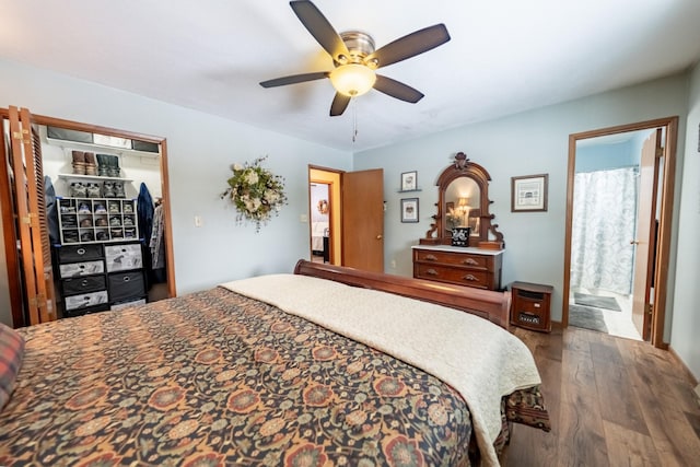 bedroom featuring ceiling fan, wood finished floors, and ensuite bathroom