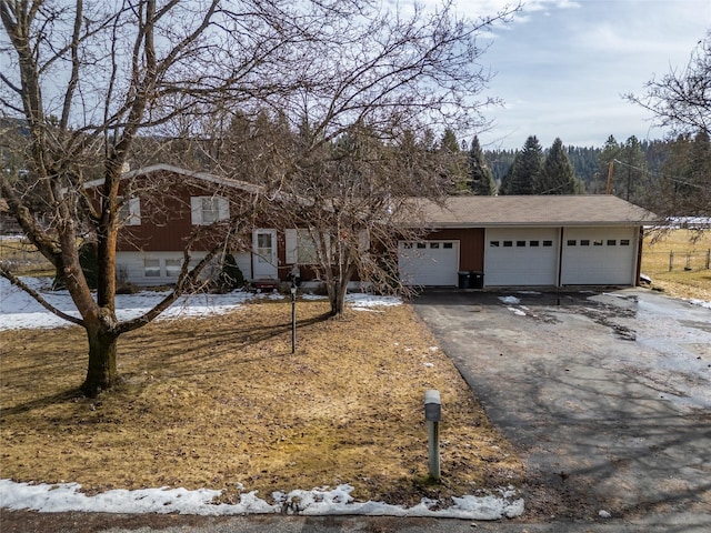 view of front facade with a garage and aphalt driveway