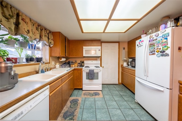 647 Northwood Ave, Libby, MT 59923 - kitchen with white appliances, light countertops, brown cabinetry, and light tile patterned floors