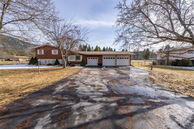 647 Northwood Ave, Libby, MT 59923 - ranch-style home with driveway and an attached garage
