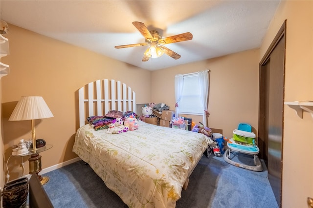 carpeted bedroom featuring ceiling fan and baseboards