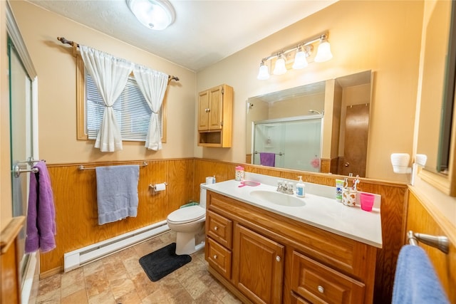 bathroom featuring a baseboard radiator, wooden walls, a wainscoted wall, vanity, and a shower stall