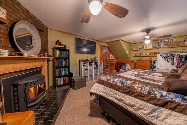 647 Northwood Ave, Libby, MT 59923 - bedroom with a wood stove, carpet, crown molding, and a textured ceiling