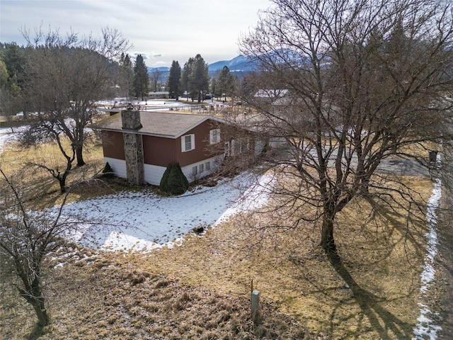 snowy aerial view featuring a mountain view