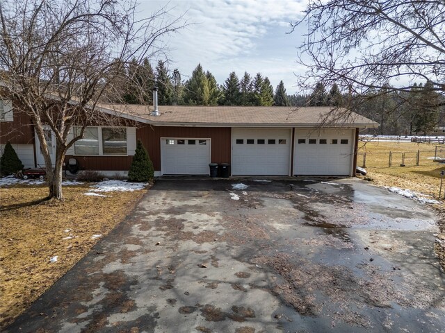 647 Northwood Ave, Libby, MT 59923 - view of front of home with asphalt driveway and a garage