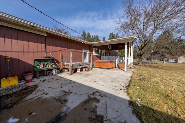 exterior space with a hot tub