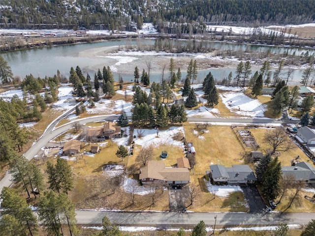 snowy aerial view with a water view