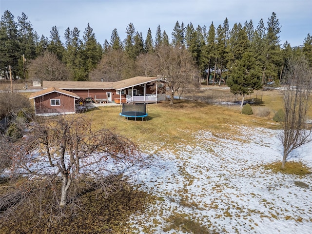 647 Northwood Ave, Libby, MT 59923 - back of house with a trampoline and a lawn
