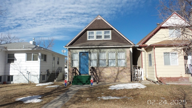 view of front of home featuring entry steps and stone siding