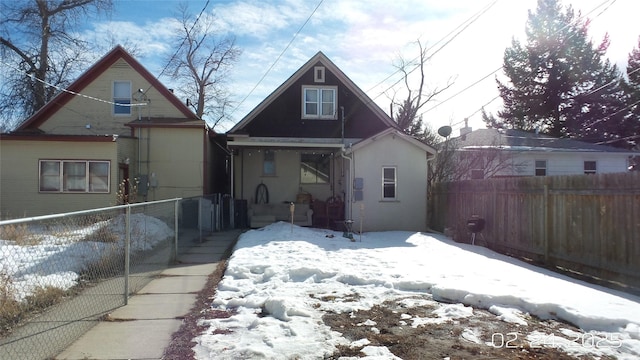 view of front facade with fence private yard and stucco siding