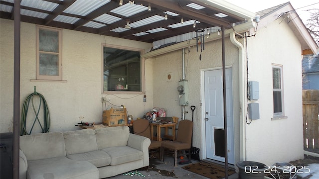 exterior space with a pergola, outdoor lounge area, and stucco siding