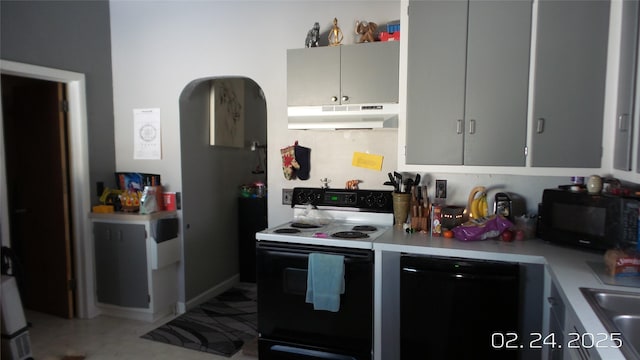 kitchen with gray cabinetry, light countertops, under cabinet range hood, and black appliances