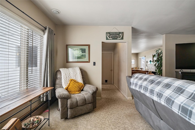 bedroom with light carpet and baseboards