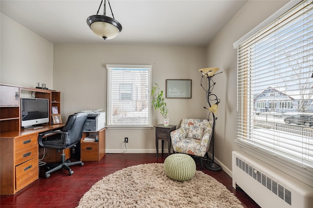 home office featuring radiator heating unit and baseboards