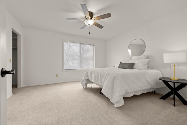 bedroom with ceiling fan, baseboards, and light colored carpet