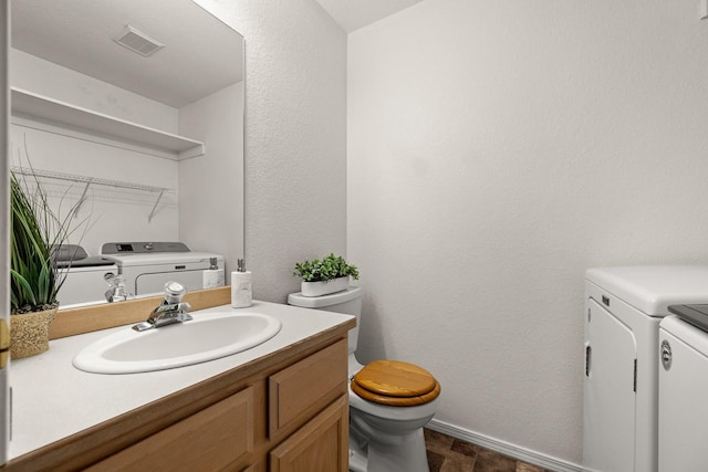 312 Ponderosa St, Kalispell, MT 59901 - half bathroom featuring washing machine and clothes dryer, vanity, and a textured wall