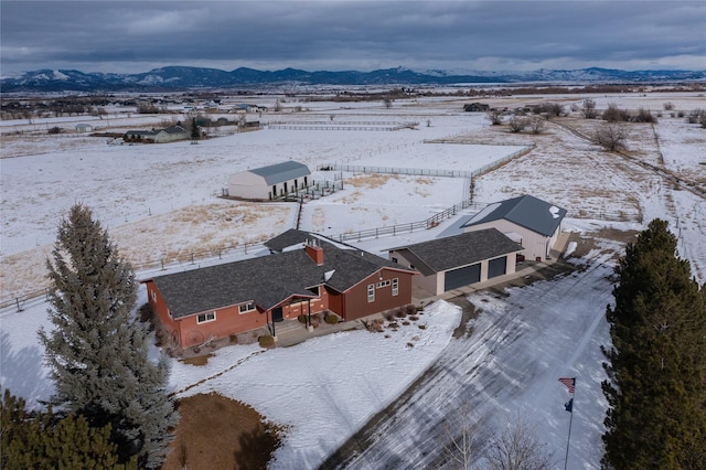 snowy aerial view featuring a mountain view