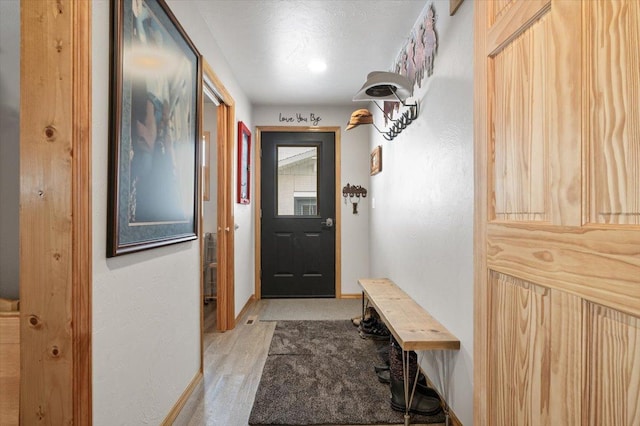 mudroom with baseboards and light wood finished floors