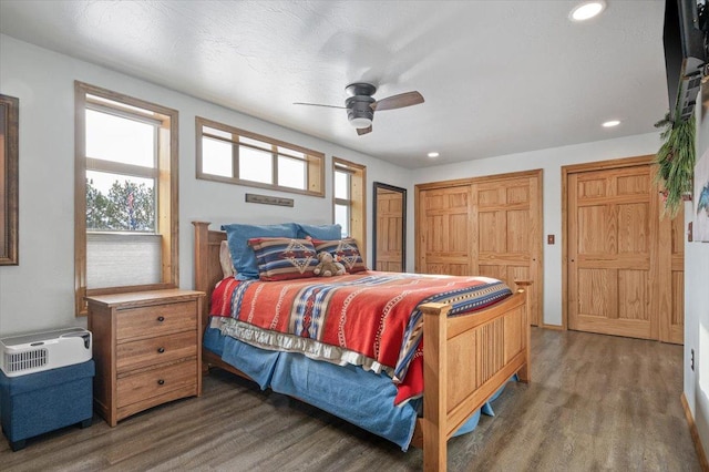 bedroom with dark wood finished floors, a ceiling fan, and recessed lighting