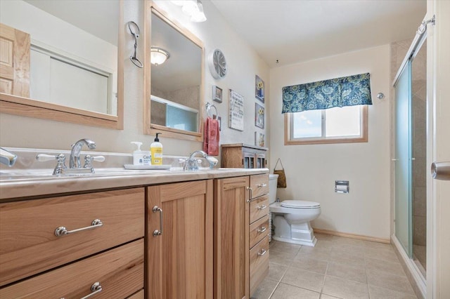 full bathroom with double vanity, a shower with shower door, a sink, baseboards, and tile patterned floors