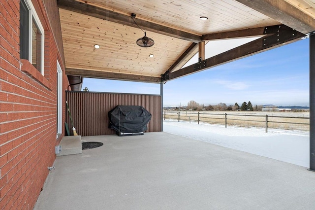 view of patio featuring a rural view and fence