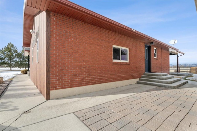 view of side of home featuring brick siding