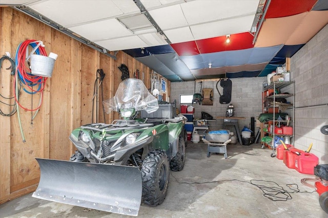 garage with concrete block wall and wooden walls