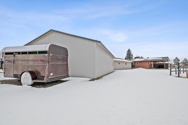 snow covered structure featuring an outdoor structure