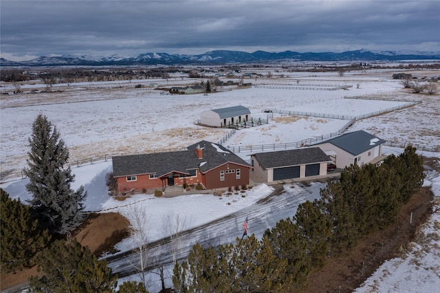 snowy aerial view with a mountain view