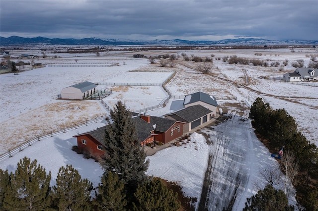 snowy aerial view featuring a mountain view