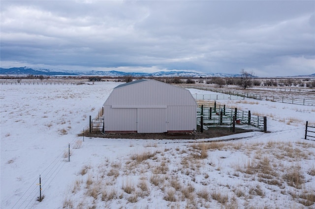 exterior space with a rural view, a mountain view, and fence