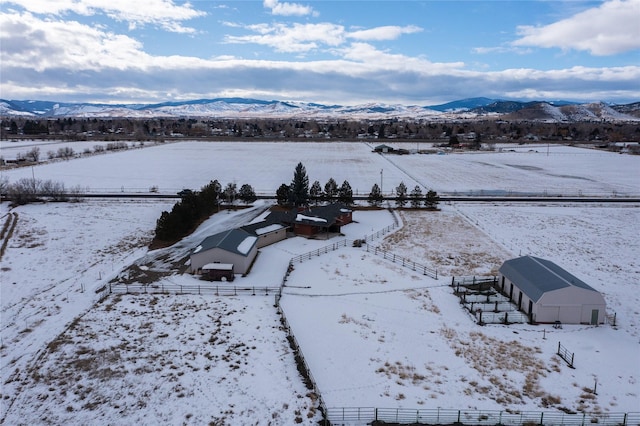 snowy aerial view featuring a mountain view