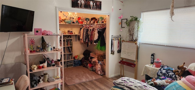 bedroom with a closet and wood finished floors