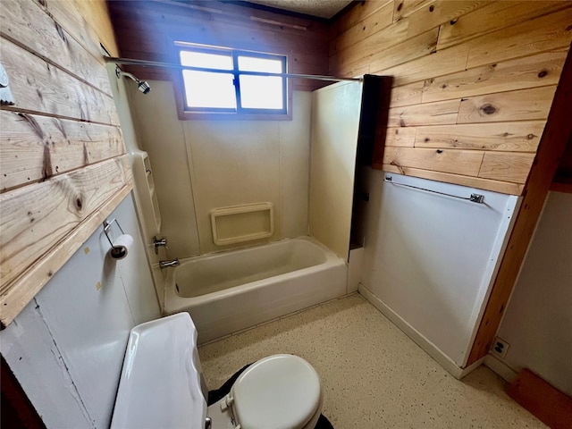 full bath with wood walls, tub / shower combination, and toilet