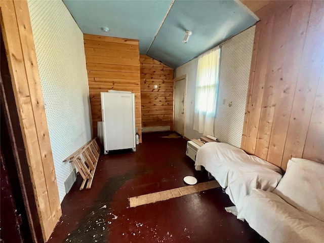 unfurnished bedroom featuring a baseboard radiator, vaulted ceiling, and wooden walls