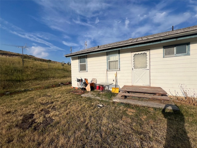 back of property featuring a lawn