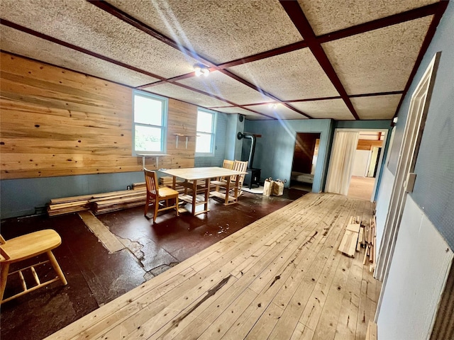 dining area featuring wood-type flooring and wooden walls