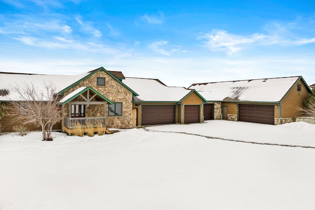 rustic home with a garage and stone siding