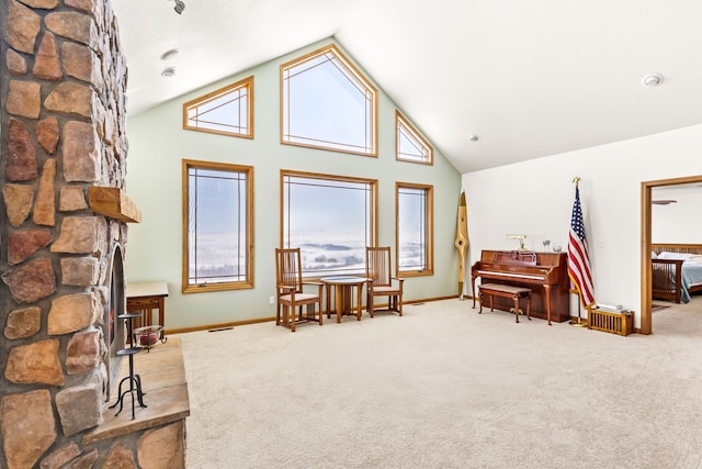 interior space featuring high vaulted ceiling, carpet flooring, and baseboards