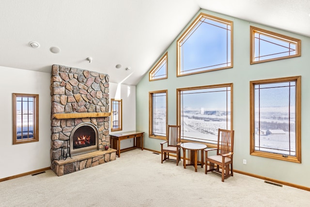 sitting room with high vaulted ceiling, carpet, a fireplace, and visible vents