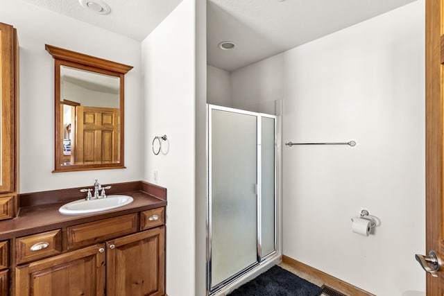 full bath featuring a stall shower and vanity