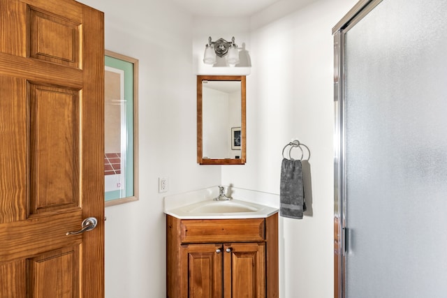 full bathroom with a stall shower and vanity