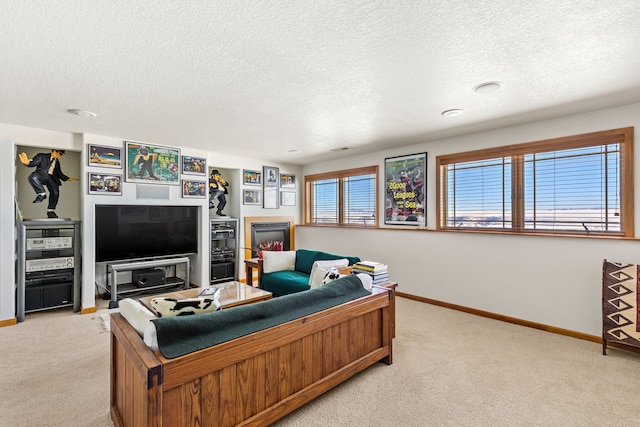 living area with light carpet, baseboards, and a textured ceiling