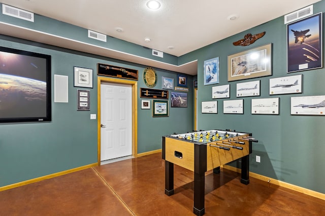 recreation room with concrete flooring, visible vents, and baseboards